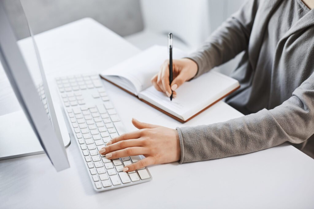 i-can-handle-multi-tasks-cropped-shot-successful-girl-typing-keyboard-making-notes-while-looking-computer-screen-studying-new-business-graphic-there-is-no-time-rest-scaled.jpg